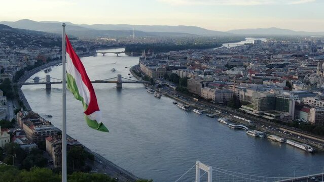 Drone passing huge hungarian flag on Gellert hill in Budapest, Hungary