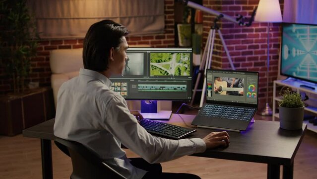 Movie and sound engineer editing video footage on post production software to have visual effects and color grading on film montage. Cinematic look to create content on creative app. Handheld shot.