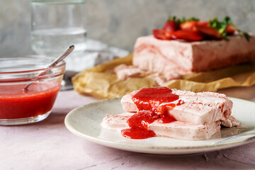 Italian strawberry dessert Semifreddo with sauce - cold dessert like an ice-cream sliced on plate