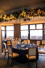 Banquet hall for celebrating a wedding, at server tables, flowers.