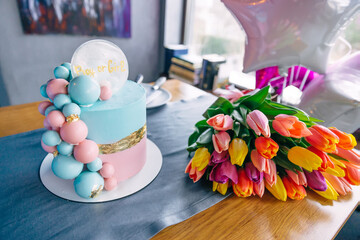 holiday, parents find out the sex of the child. Beautiful pink-blue cake and a beautiful bouquet...
