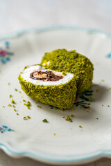 Turkish specific dessert muska pestil with pistachio powder and hazelnut chocolate cream . Amulet.