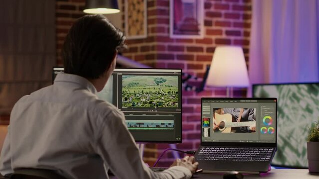 Multimedia artist editing video montage with sound and visual effects, creative grading with color for film production. Using footage on video editor software for cinematic look content.