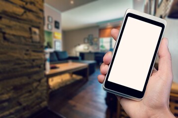 Smart home concept.  Woman holding mobile phone on home interior background. Internet of things, comfort in house