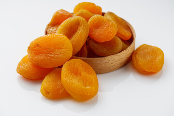 delicious dried apricots on a white acrylic background