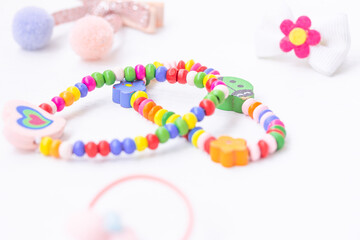 Cute colorful bracelets, nice hairpins on white background. Baby glamour concept, Accessories for girls