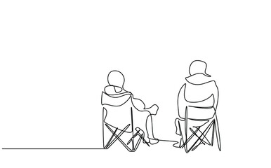 two people sitting calmly on camping chair in nature