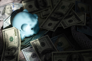 business, finance, investment, saving and corruption concept - close up of dollar cash money and piggy bank on table