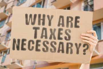 The question " Why are taxes necessary? " is on a banner in men's hands with blurred background. Duty. Executive. Problem. Wealth. Profit. Legal. Pay. Revenue. Rule. Income. Law. Money. Advice. Budget