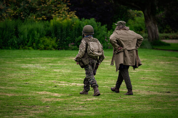 Boy in US army uniform with mum