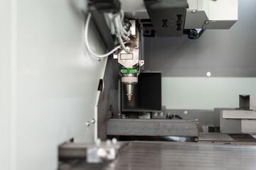 Laser cutting machine service. Detail of a cutting head. The fiber laser cutting machine. Metal manufacturing process by laser cutting machine.