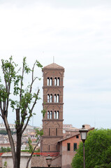 Ancient Romanesque brick bell tower structure sky background in Rome, Italy