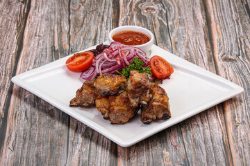 Grilled lamb ribs with tomato sauce