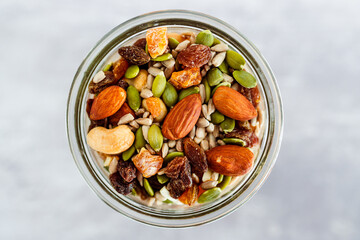 glass jar of mixed nuts including almonds cashews and pistachios, natural healthy pantry ingredients