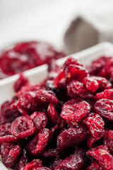 dried cranberry berry on a white wooden rustic background