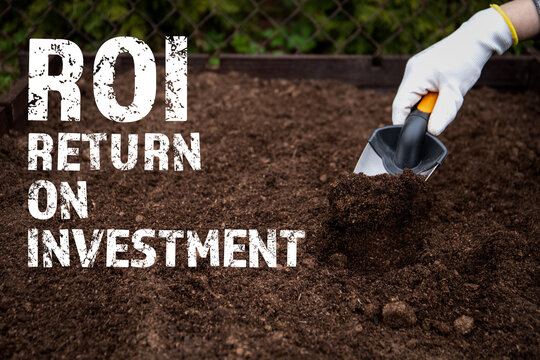 ROI Return on investment. Diging the soil with a garden shovel