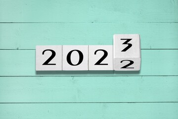 2023 on wooden block cube for new year change and start new business strategy concept.