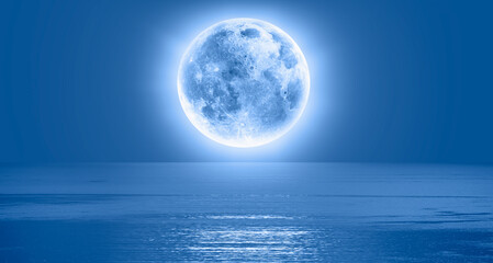 Naklejka na ściany i meble Full moon over the sea at sunset 