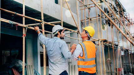 Architector and engineers or leader discussion and pointing to construction site project on workplace. Construction Worker Planning Developer Concept