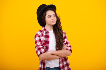 Child teen girl in magician hat, cylinder hat isolated on yellow background. Headwear. Clothes accessories. Fashion headwear for gentlemen in vintage style, old classic cylinder. - obrazy, fototapety, plakaty