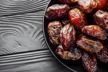 juicy royal dates on a black wooden rustic background