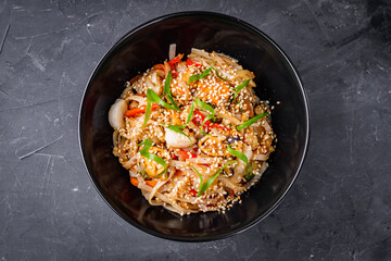 delicious chinese fried noodles on a black background