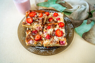 Rhubarb and strawberry cake on plate, cocktail and scarf.