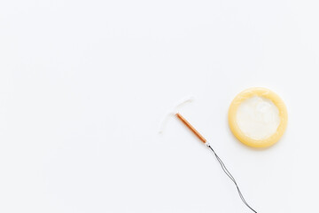 T-shaped intrauterine birth control device with condoms. Contraception concept