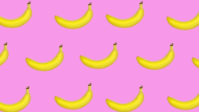 Abstract colorful animation - bananas moving at pink color background. Seamless loop animation.