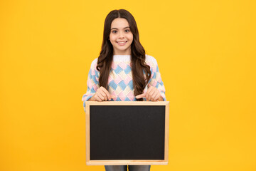 Naklejka premium Teen schoolgirl hold blackboard. Child advertising. Back to school.