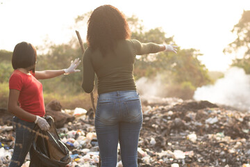 african women cleaning a refuse site