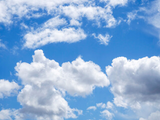 Naklejka na ściany i meble Sunny summer day. Blue sky with clouds. Abstract sky background.
