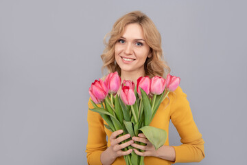 happy woman with tulips. lady hold flowers for spring holiday. girl with bouquet