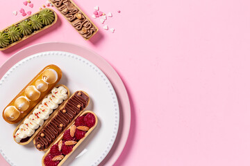 Set of delicious dessert eclairs with colorful topping