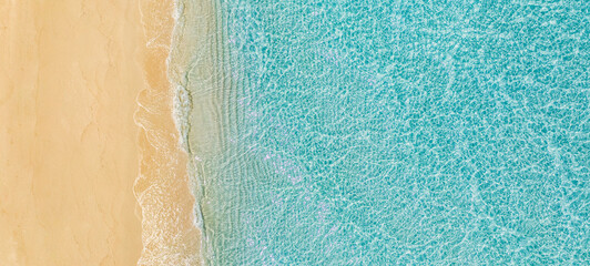 Sandy seashore with turquoise green sea water. Small waves on the beach. Beautiful paradise tropical island beach background, top aerial landscape turquoise ocean on sunny day. Freedom summer travel © icemanphotos