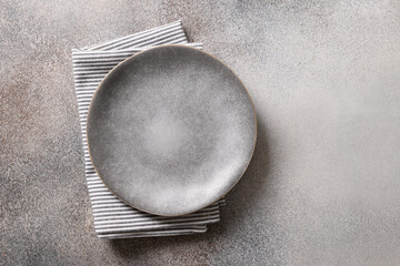 Empty gray plate and on gray background. View from above.Flat lay. Copy space. Template or mockup...