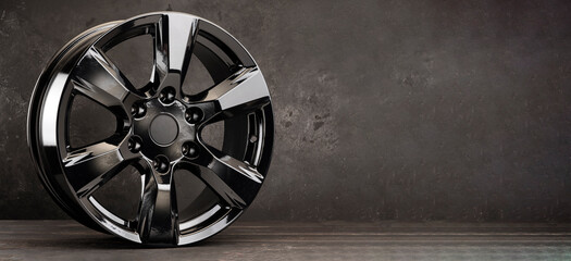 black alloy wheel for SUV car on texture background, copy space