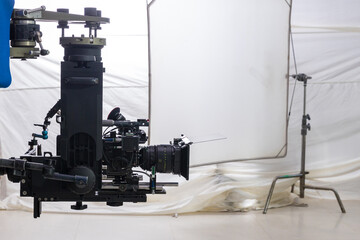 Movie shooting or video production and film crew team with camera equipment. Video camera operator working with equipment. Director of photography with a camera in his hands on the set	