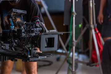 Movie shooting or video production and film crew team with camera equipment. Video camera operator...