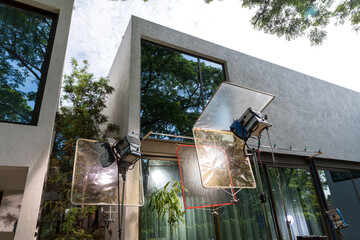 Process of filming. Spotlight illuminates. Movie set with many lamps outdoor. Movie lights outdoor	