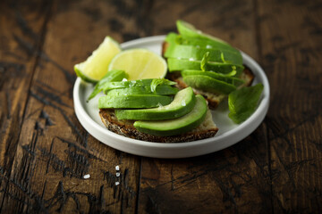 Homemade avocado toast with fresh lime