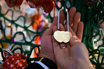 Wedding in Moscow. 40 year olds. Bride and groom hang lock