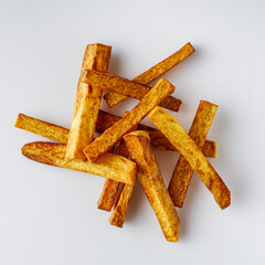 golden french fries on a white acrylic background