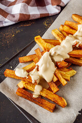 golden french fries on a dark rustic background
