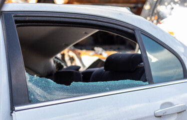 Criminal incident. Breaking into a car parked on the street. Broken side glass and the passenger...