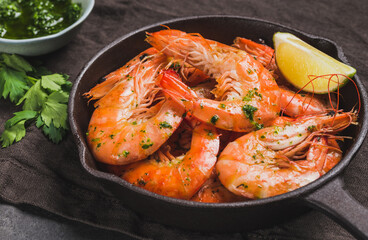 Shrimps in pan stir-fried tasty jumbo shrimps in pan on dark background close up.	