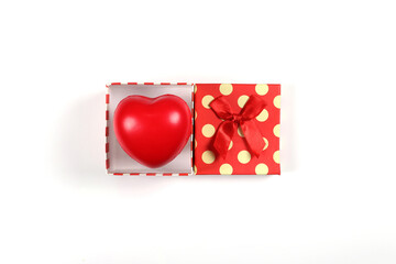 Red gift boxes with red hearts with ribbon bows placed on a white background. Gift box top view image has copy space.