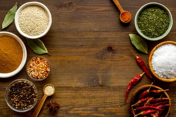 Foto op Canvas Colorful herbs and spices in bowls for cooking. Pepper chili, laurel leaf, salt and curry © 9dreamstudio