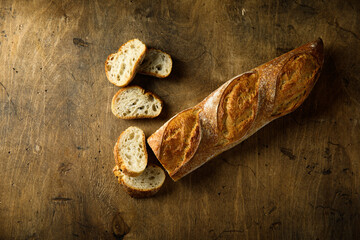 Traditional homemade baguette bread on a wooden table
