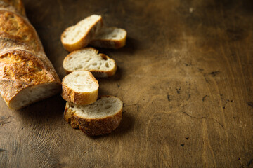 Traditional homemade baguette bread on a wooden table